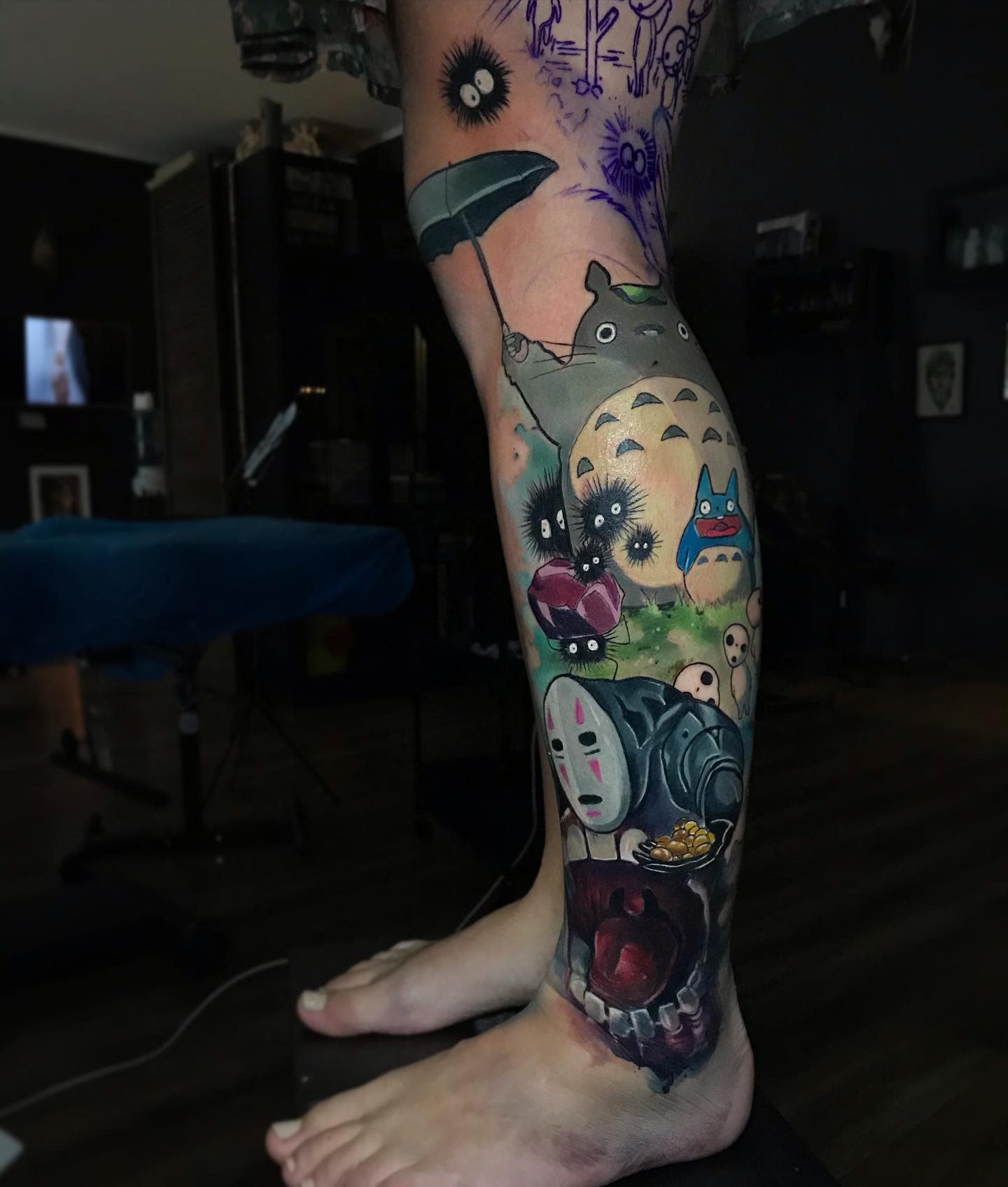 Colorful Studio Ghibli leg tattoo featuring multiple iconic characters